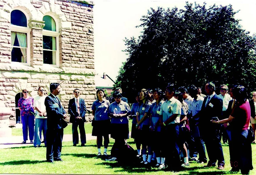 2000 年6 月27 日, 姚聰榮校長率師生組拔河隊至加拿大尋根,並協助淡水鎮與牛津郡締結姊妹市。此行除拜會 Woodstock 市政廳、加拿大長老教會總會,並與馬偕博士四位孫輩敘舊。圖中為姚聰榮校長帶領學生在牛津郡政廳前廣場齊唱校歌。